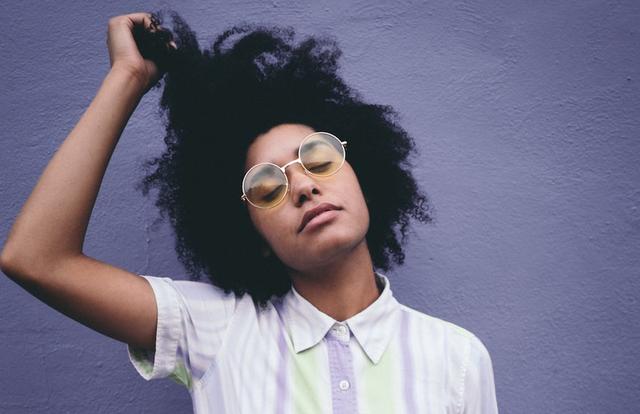 black woman pulling at her curls