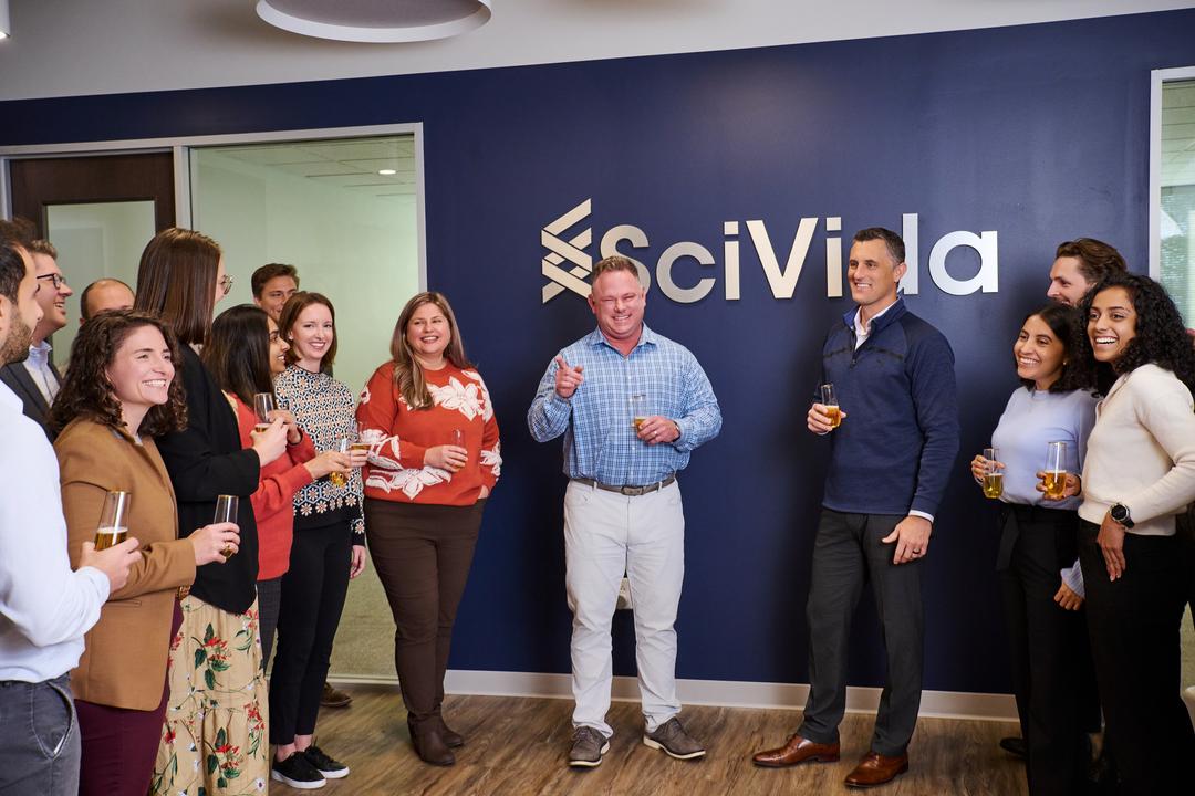 employees posing for a group shot at a happy hour