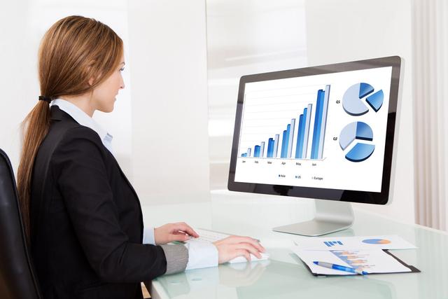 woman working on her computer with graphs